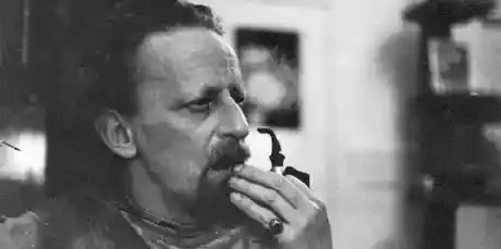 black and white photograph of a man eating food