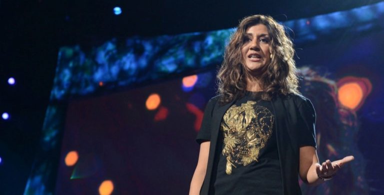 a woman standing on stage with her hands out