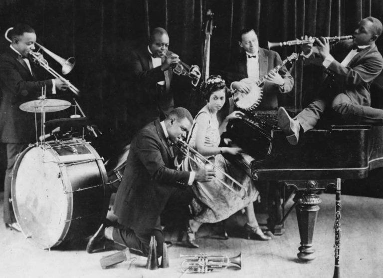a group of men and women playing musical instruments