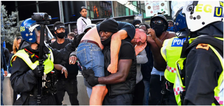 a man is being hugged by police officers