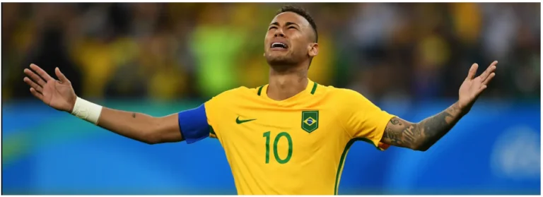 a soccer player with his arms outstretched in the air