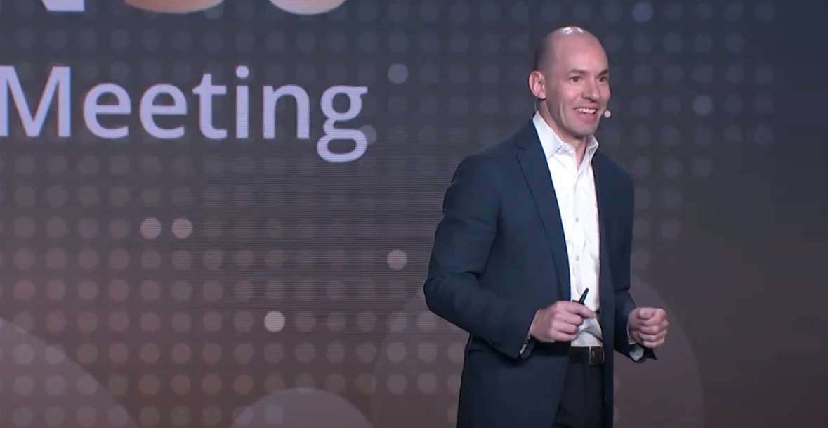 a man in a suit is standing on stage