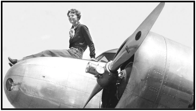 a woman sitting on the wing of an airplane