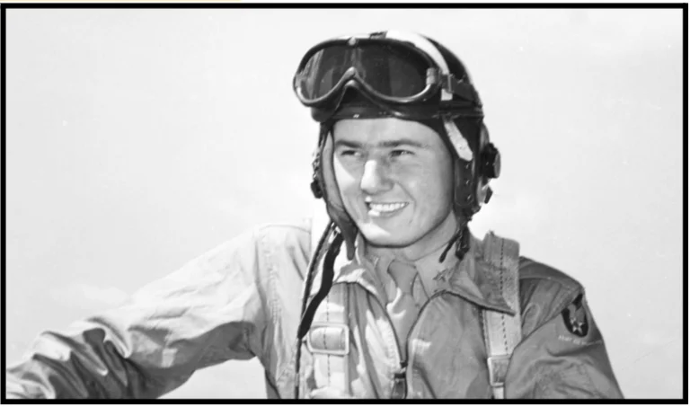 a black and white photo of a man wearing a pilot's helmet