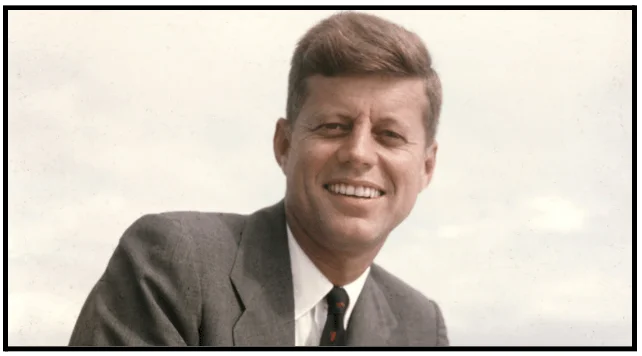 a man in a suit and tie smiling