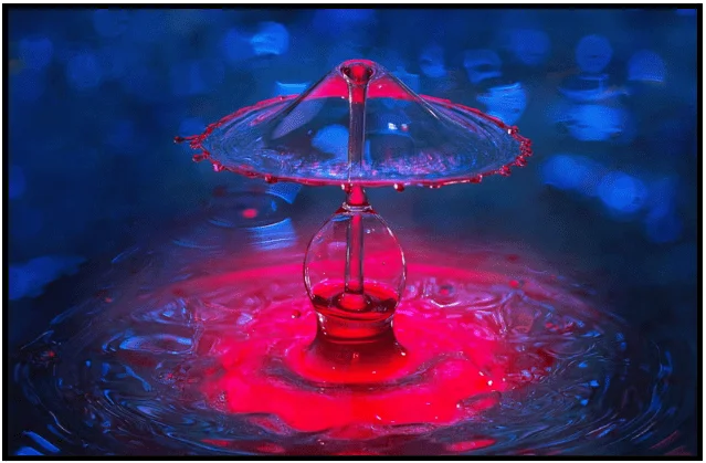 a red light is shining on a blue background