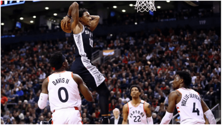 a basketball player jumping up to dunk the ball