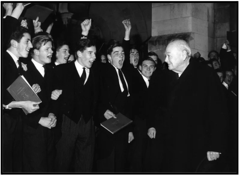 a group of men standing next to each other in front of a crowd